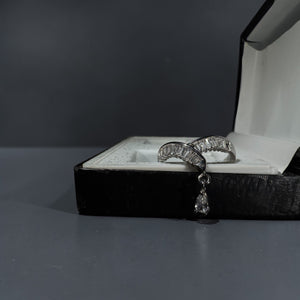 Silver stainless steel adjustable baguette crystal arc ring with dangling teardrop charm for women modern luxury jewellery Aura Collection