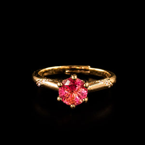 Aura Rosé Royale Ring featuring a brilliant rose-pink crystal solitaire set in a polished gold-tone band with sparkling accent stones.
