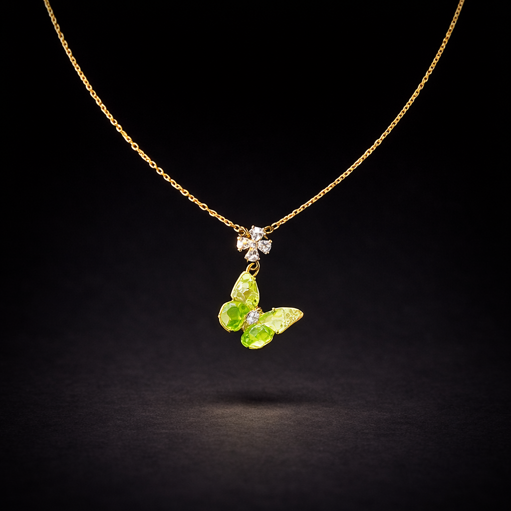Gold necklace with green crystal butterfly pendant and sparkling flower connector