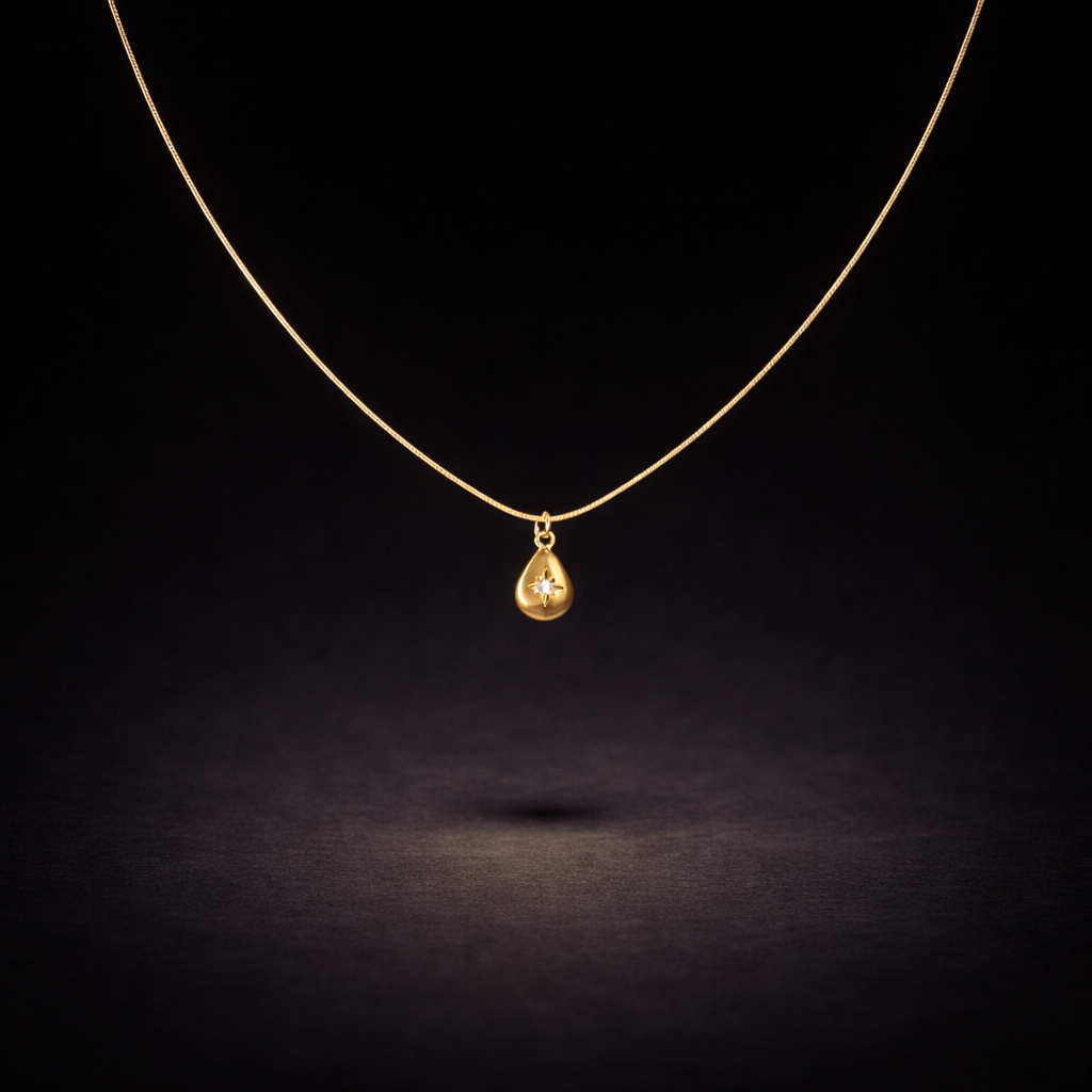 Gold teardrop pendant necklace with small crystal accent