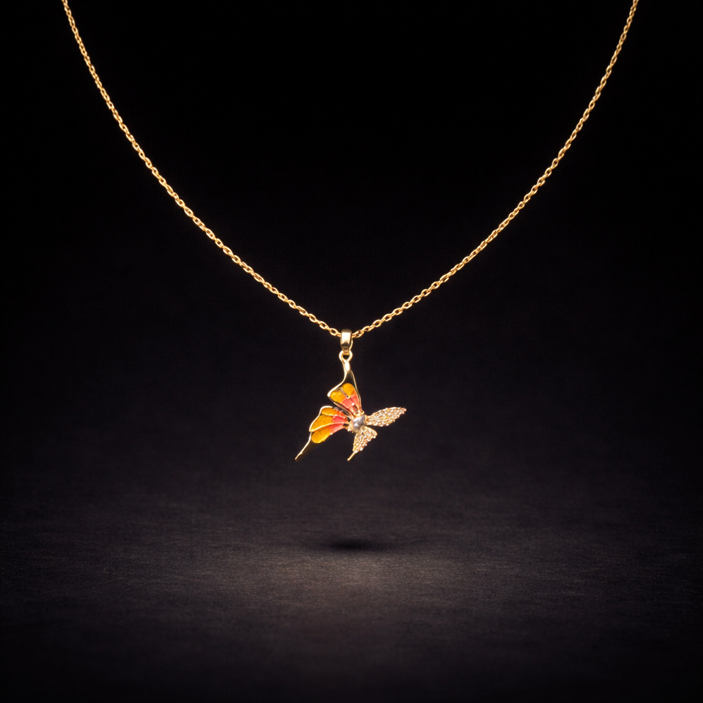 Gold butterfly pendant necklace with orange enamel wings and crystal detail