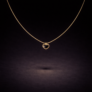Gold necklace with black heart-shaped pendant on delicate chain