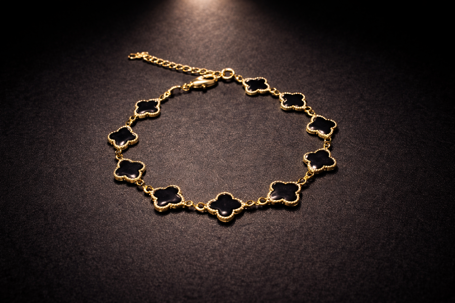 Gold adjustable clover charm bracelet with black enamel motifs for women luxury jewellery