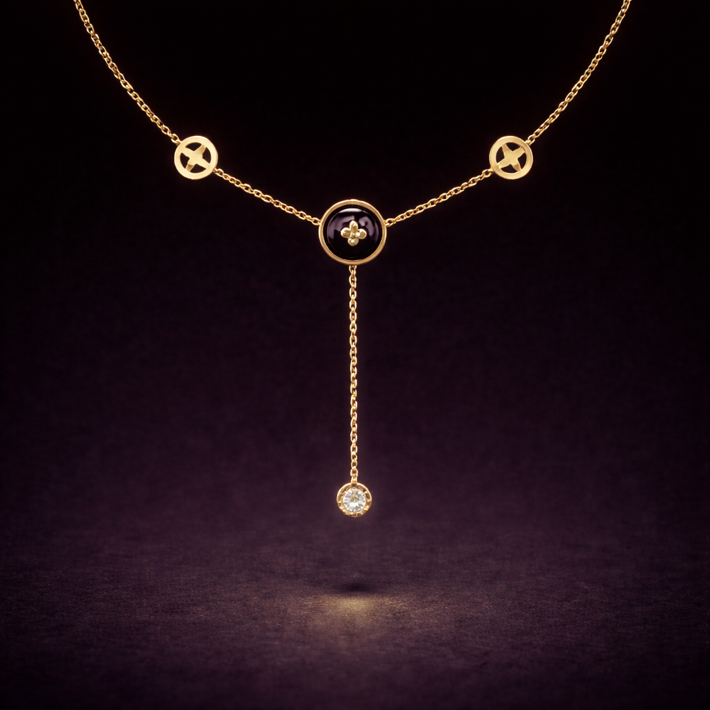 Gold necklace with black clover pendant and crystal drop chain detail