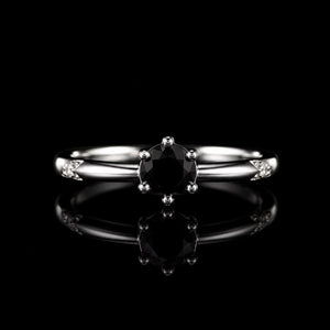Aura Midnight Sovereign Ring featuring a brilliant black crystal solitaire set in a polished silver-tone band with sparkling accent stones.