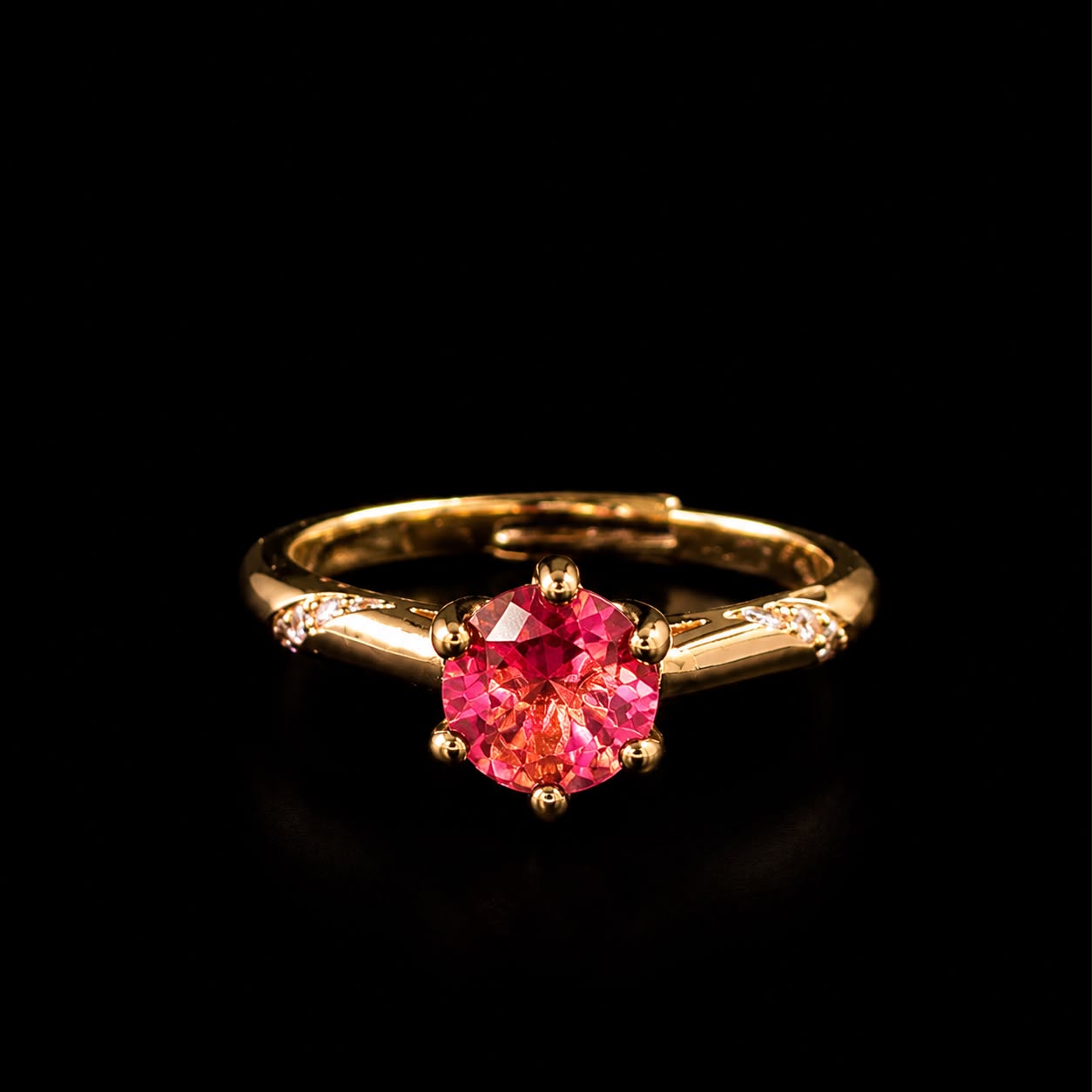 Aura Rosé Royale Ring featuring a brilliant rose-pink crystal solitaire set in a polished gold-tone band with sparkling accent stones.